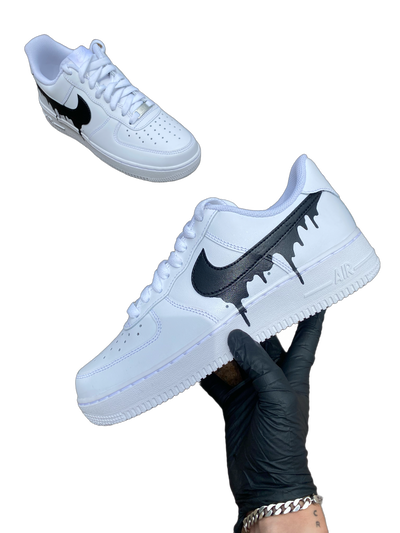 White sneakers with a black drip design