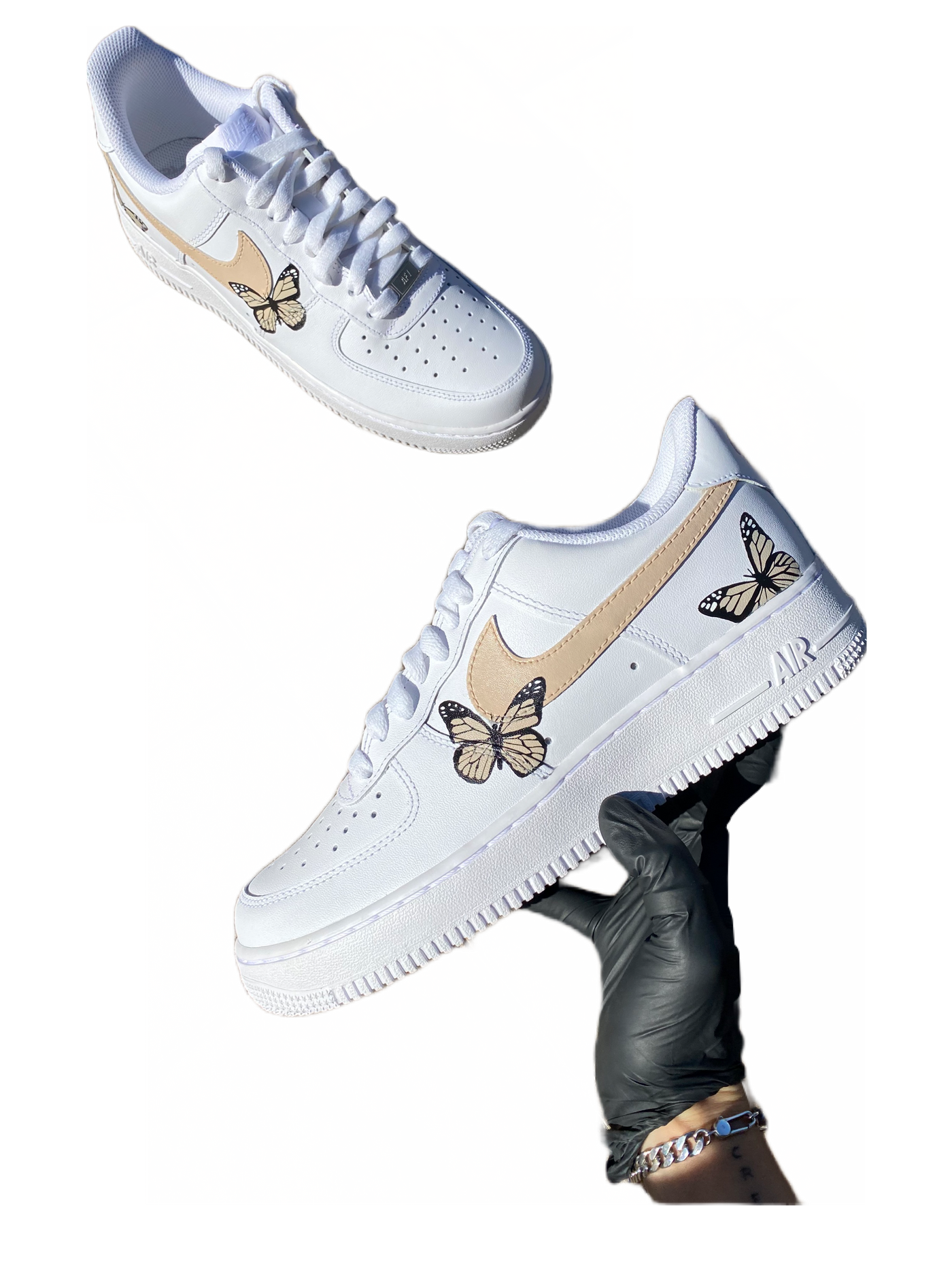 White sneakers with hand-painted butterflies in beige and peach tones. Checkmark painted beige