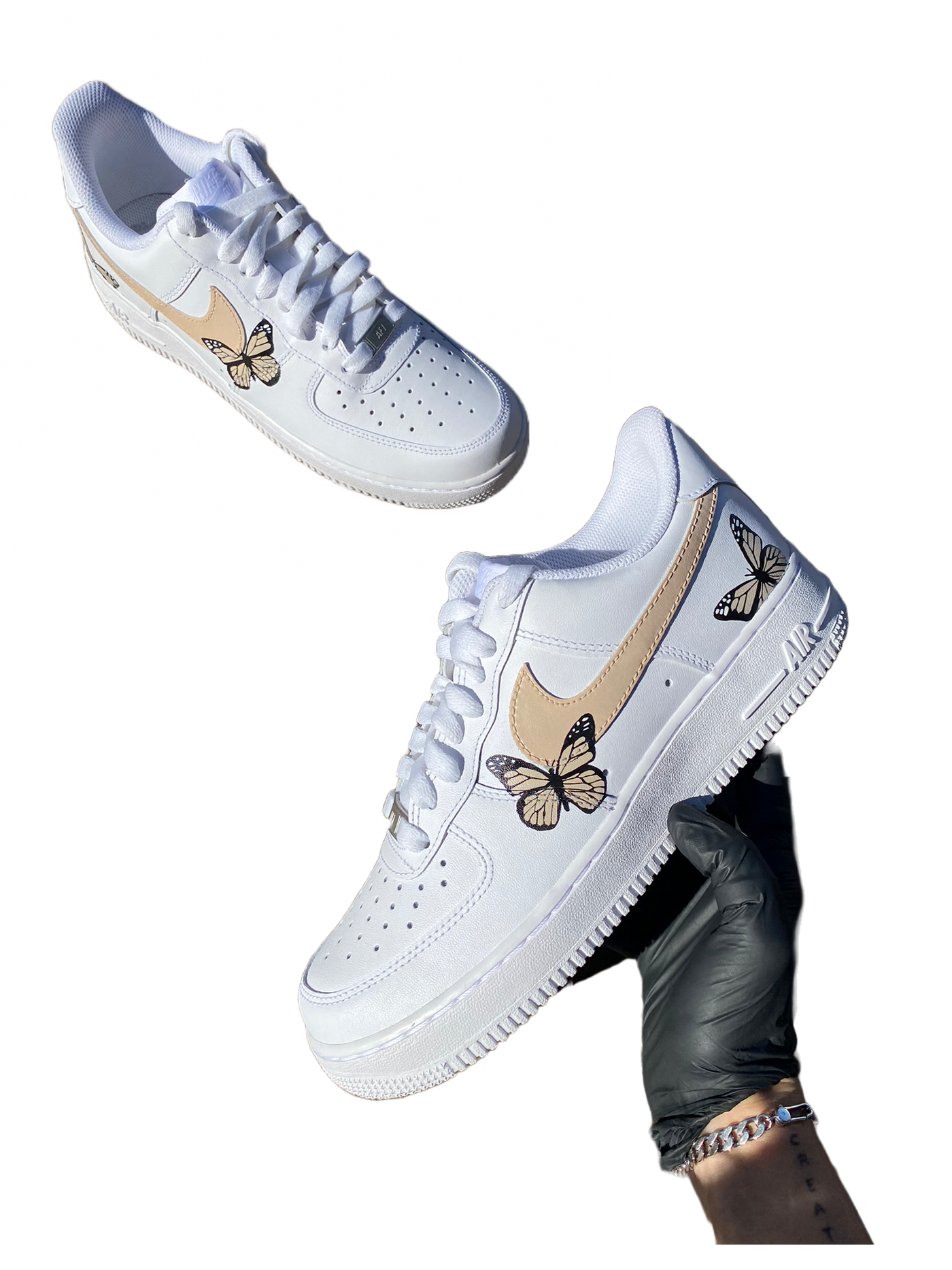 White sneakers with hand-painted butterflies in beige and peach tones. Checkmark painted beige