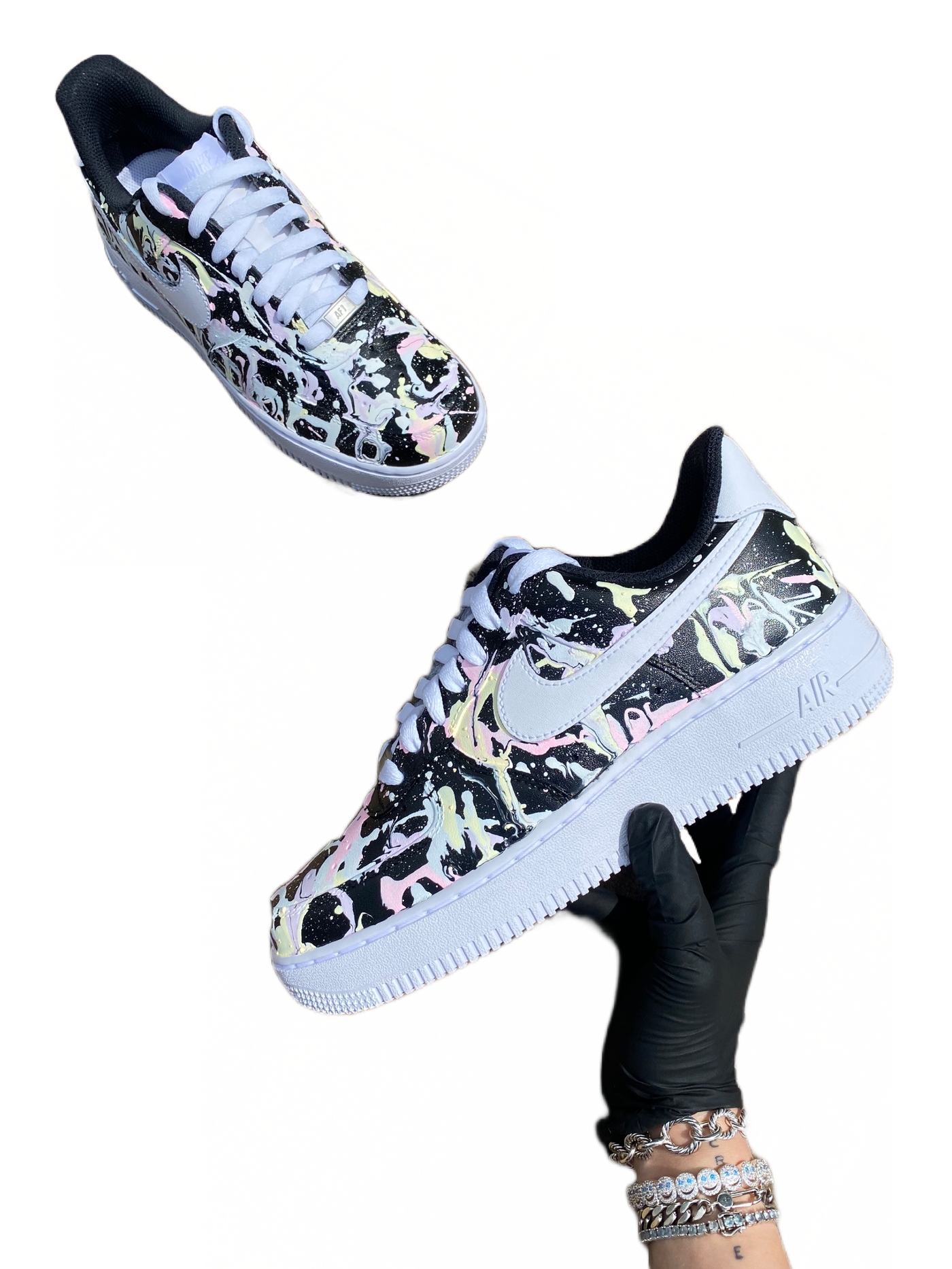 Glow-in-the-dark sneakers with a colorful abstract splatter paint design