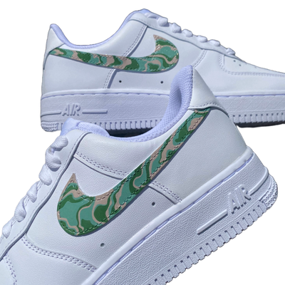 Close up of hand-painted spiral design on what would otherwise be a white pair of Air Force 1's. Colors include moss green, forest green and biege.