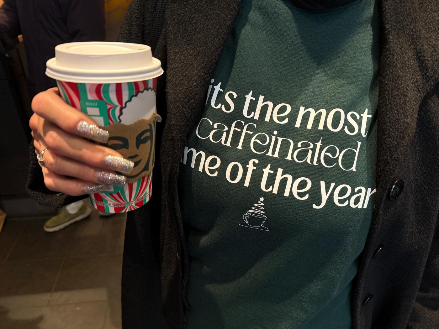 Customer picture of a custom forest green sweatshirt with a funny holiday coffee-themed graphic and saying