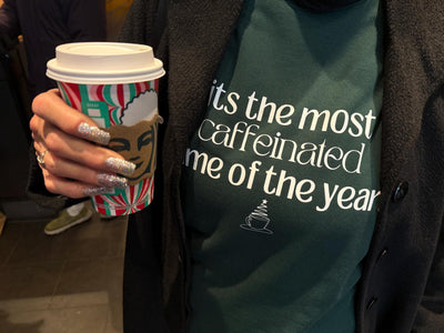 Customer picture of a custom forest green sweatshirt with a funny holiday coffee-themed graphic and saying