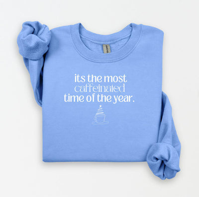 Custom Carolina blue sweatshirt with a funny holiday coffee-themed graphic and saying