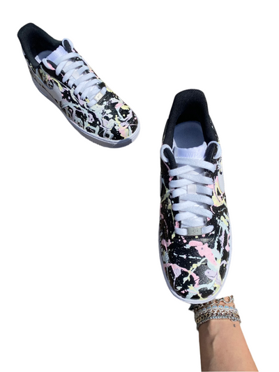 Glow-in-the-dark sneakers with a colorful abstract splatter paint design